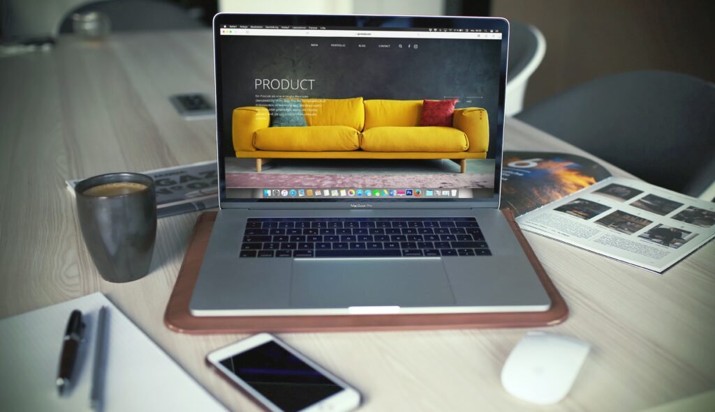 Laptop with couch on screen, table setup