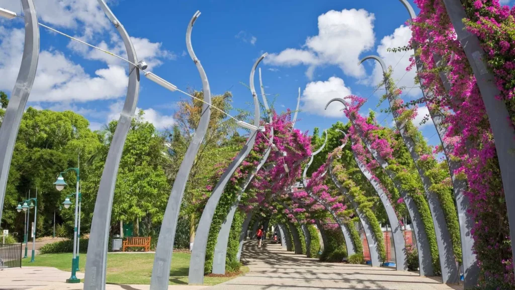 Bougainvillea archway in a sunny park pathway
