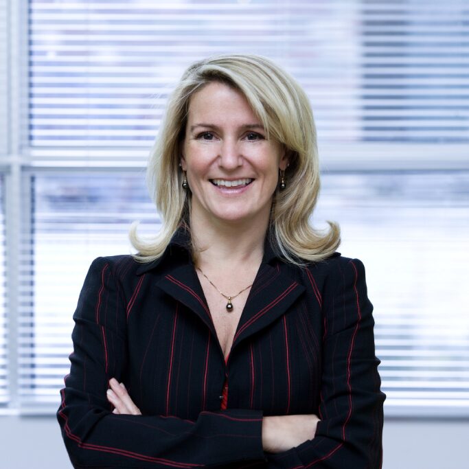 Professional woman smiling in business attire.