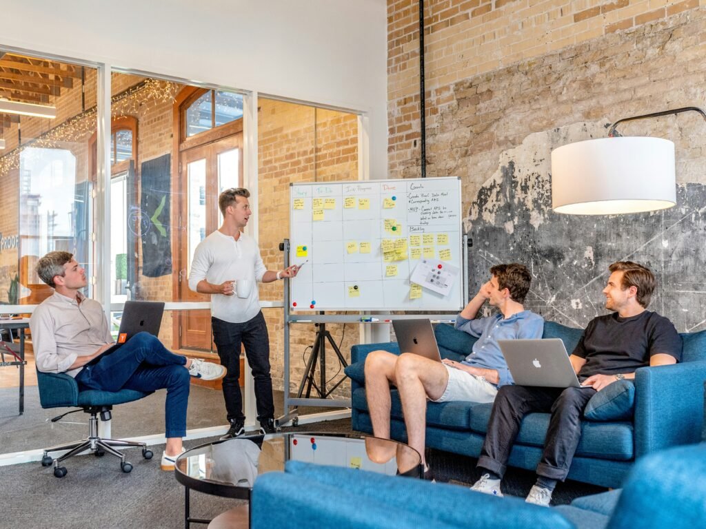 Team collaborating around a whiteboard in modern office.