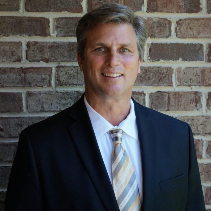 Man in suit with brick wall background