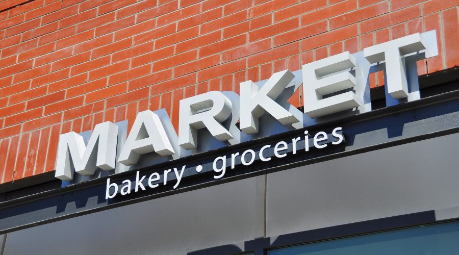 Market sign for bakery and groceries store.