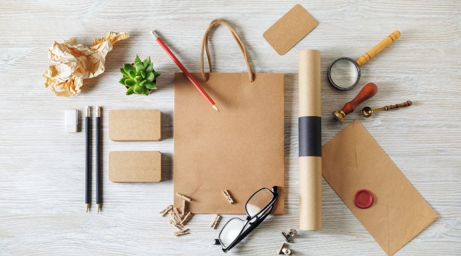 Stationery items arranged on a wooden desk