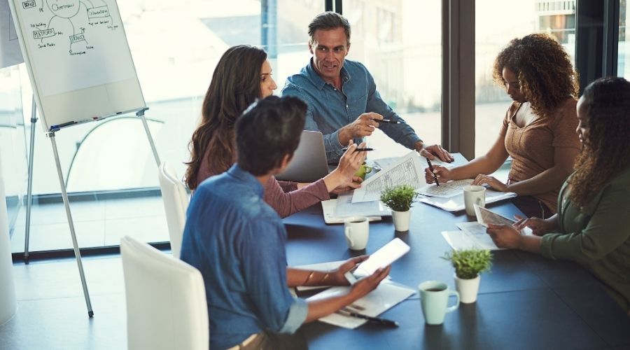 Diverse team collaborating in modern office meeting.
