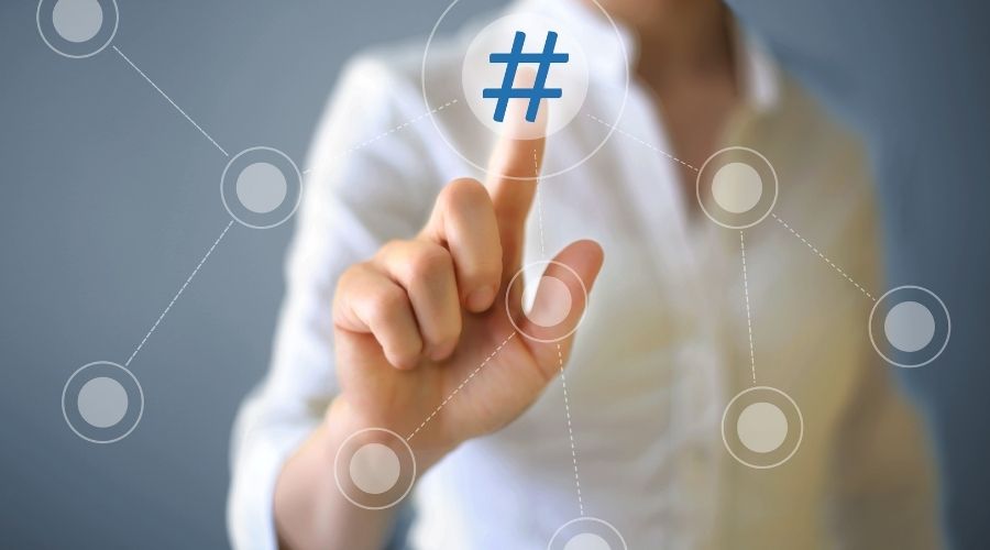 Person touching digital hashtag symbol on screen