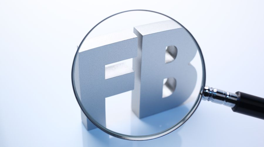 Magnifying glass highlighting 'FB' letters.