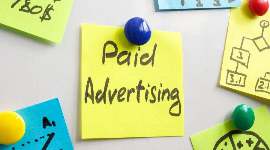 Post-it note with 'Paid Advertising' message