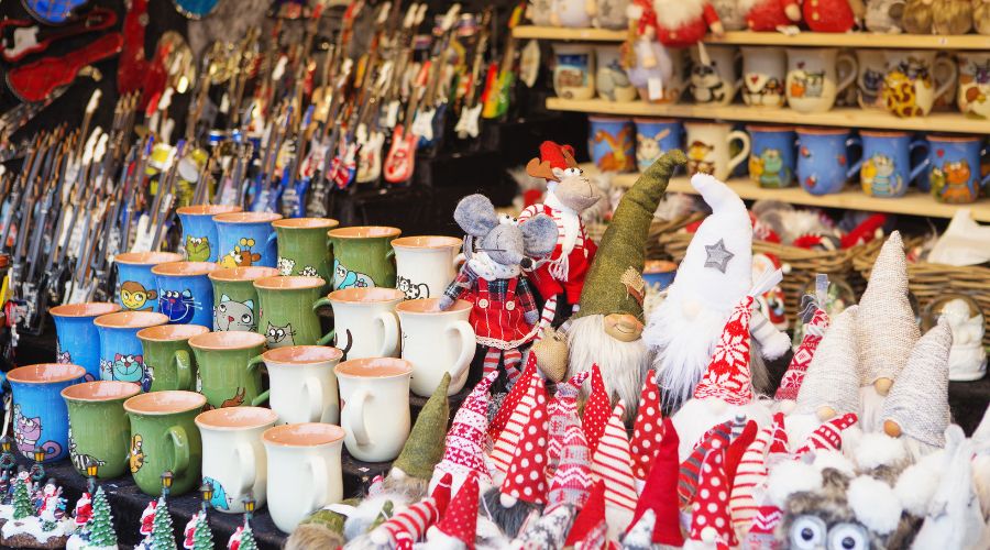 Christmas market stall with mugs and holiday decorations.