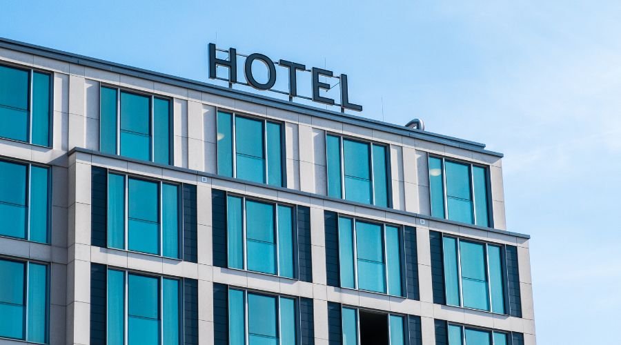 Modern hotel building exterior with large windows.