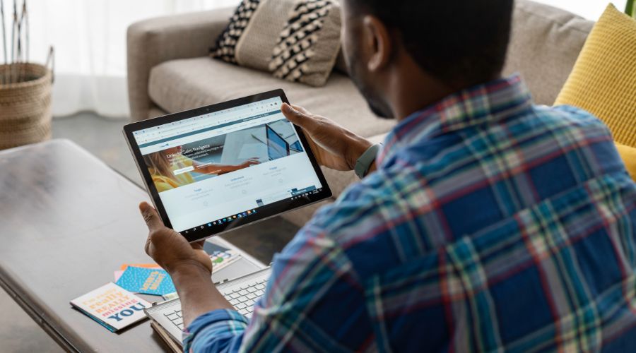 Person browsing LinkedIn on a tablet.