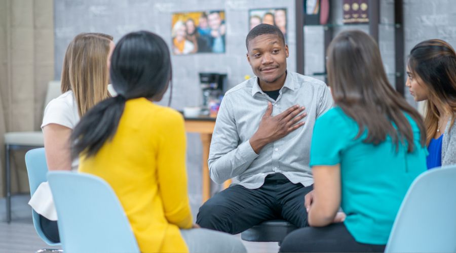 Diverse group having a discussion in a circle.