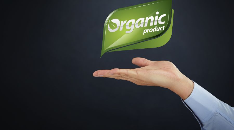 Hand holding organic product label graphic.