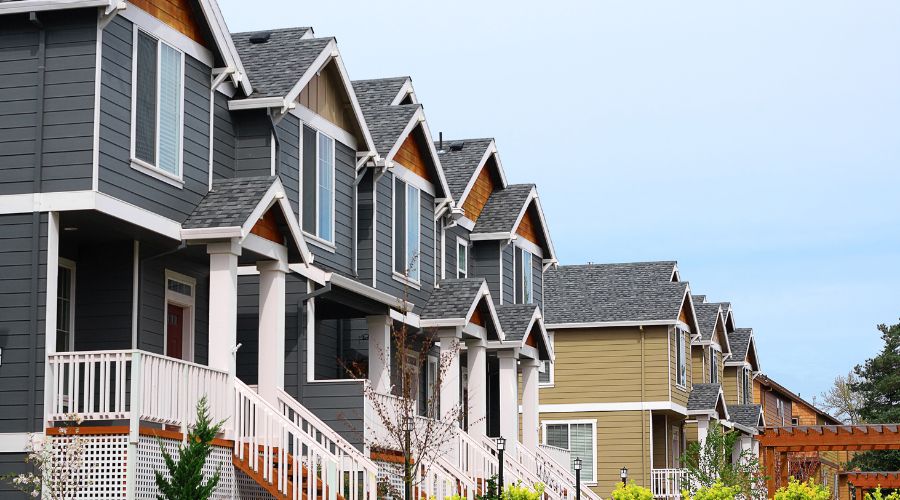 Row of modern suburban houses under clear sky.