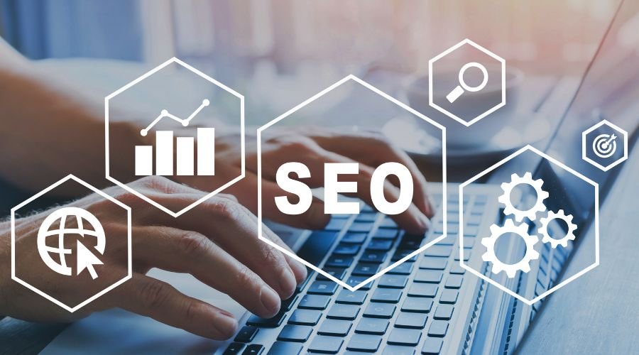 Hands typing with SEO icons overlay.