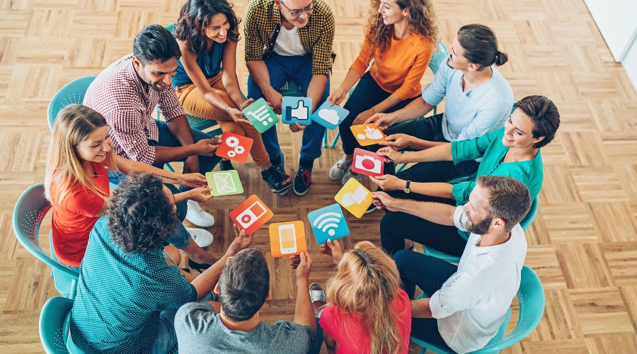 People holding digital icon cards in a circle