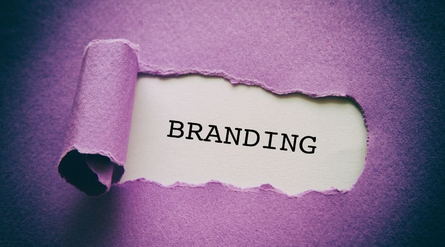Torn paper revealing the word 'branding'