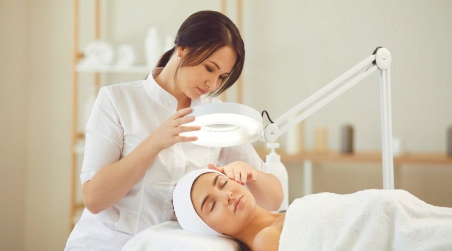 Esthetician performing facial treatment in spa.