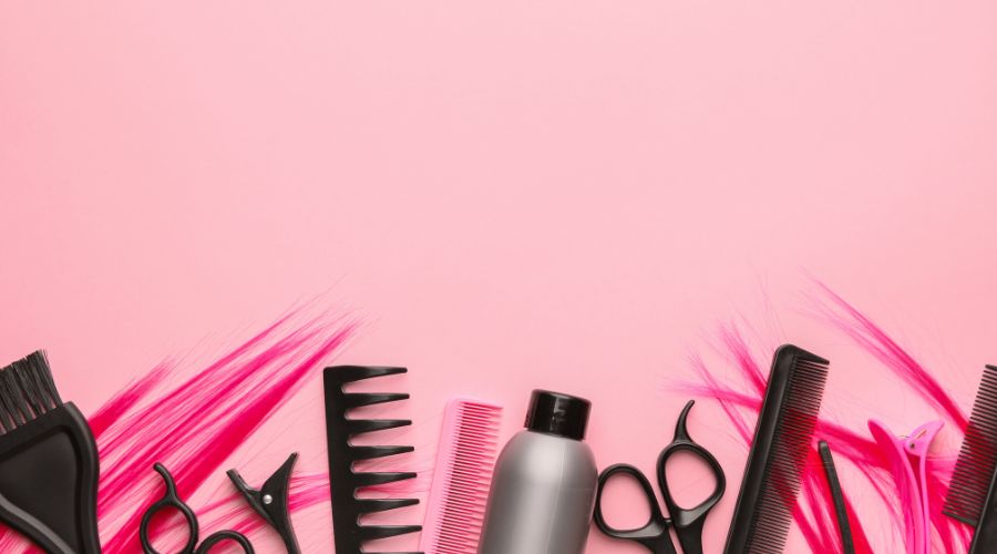 Hair styling tools on pink background