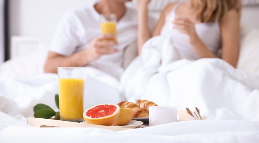 Breakfast in bed with juice and pastries.