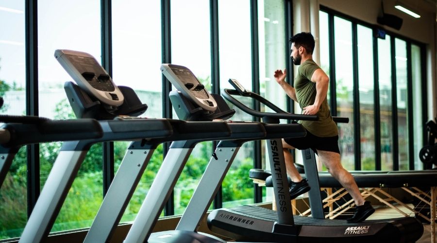 Man running on treadmill in gym