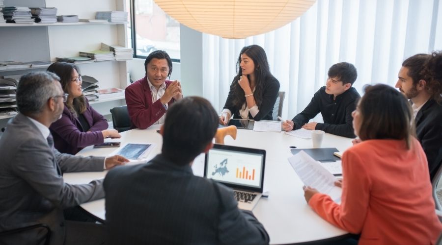 Diverse team in business meeting discussing strategy.