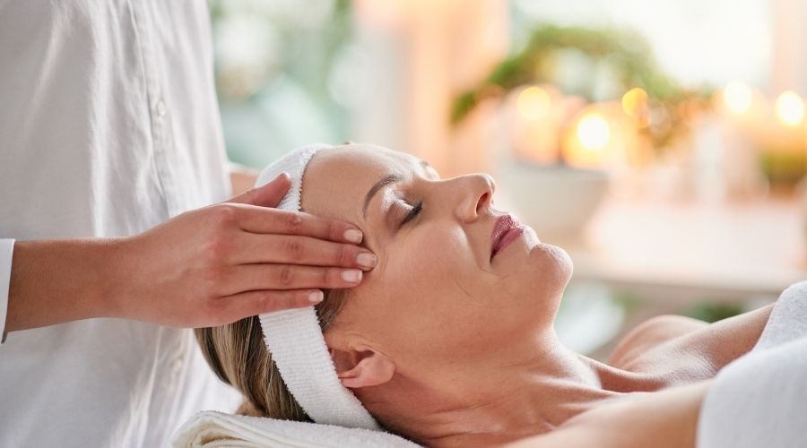 Woman enjoying facial massage at a spa