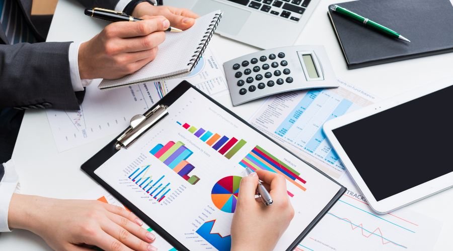 Business meeting analyzing financial charts and graphs.