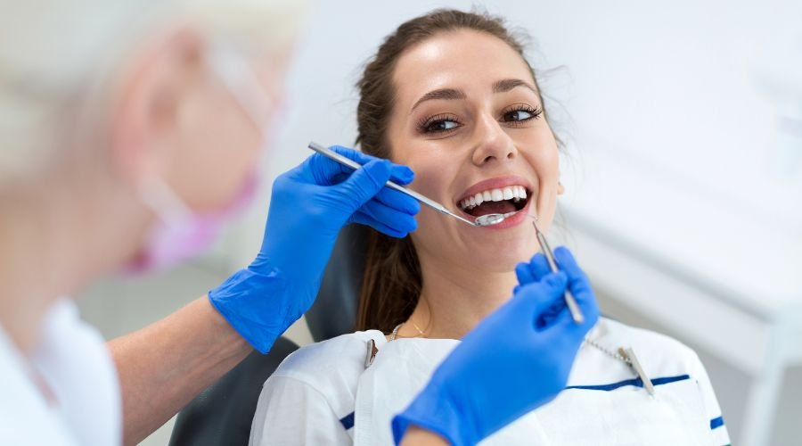 Woman receiving dental check-up from dentist.