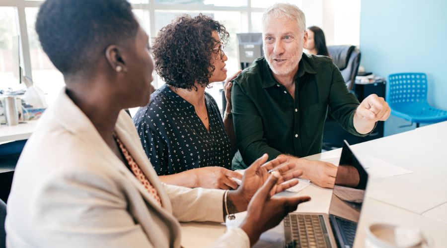 Diverse colleagues discussing at a meeting table.