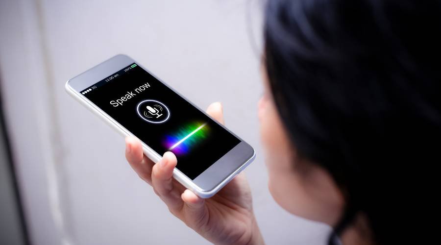 Person using voice command on smartphone.