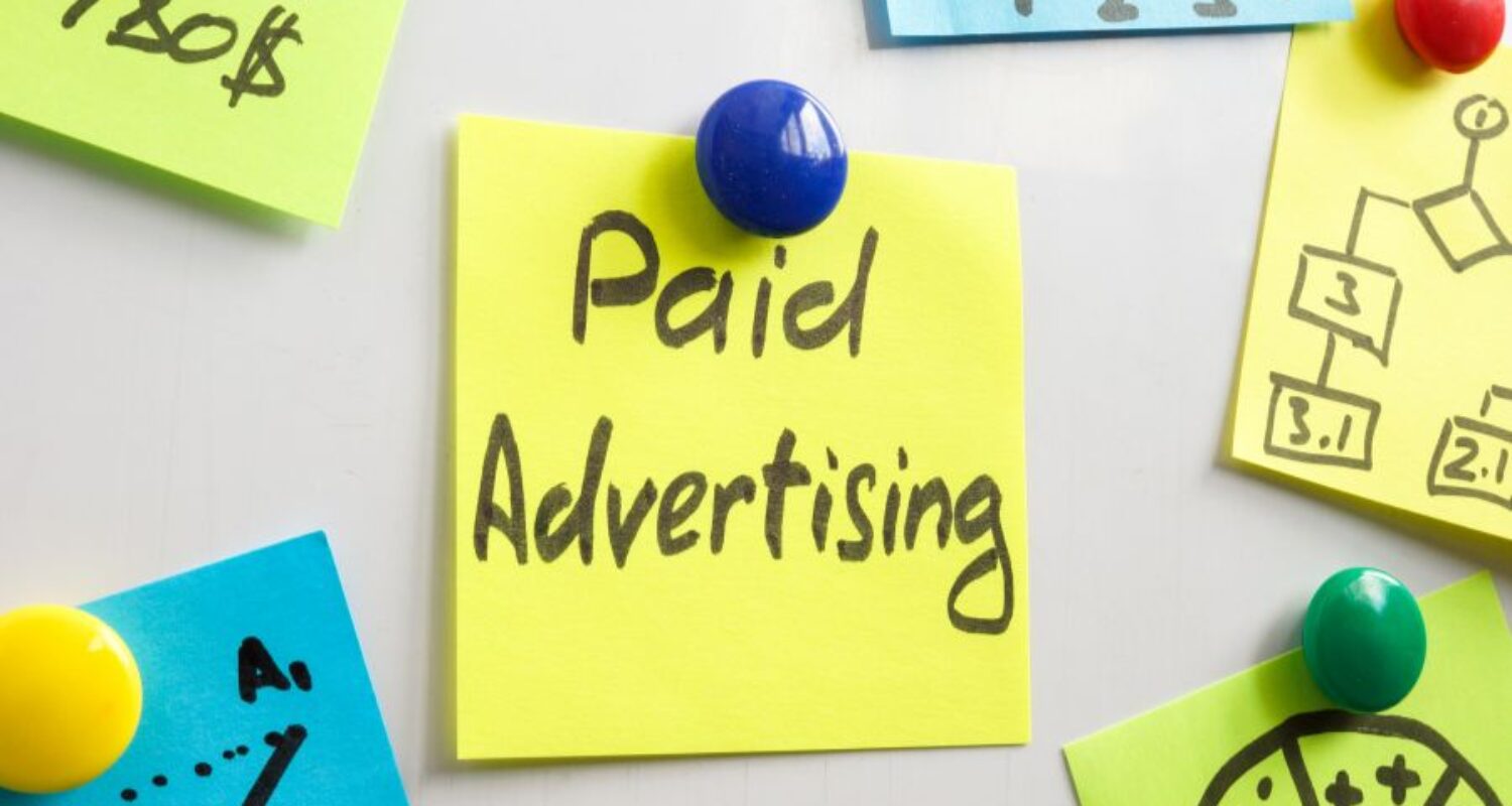 Post-it note with 'Paid Advertising' message