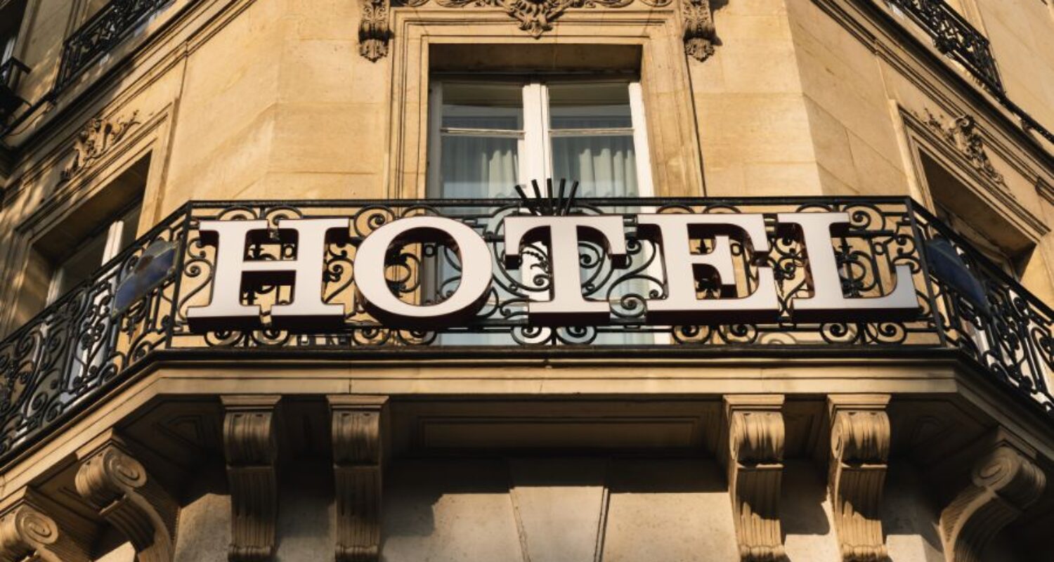 Hotel sign on building balcony exterior