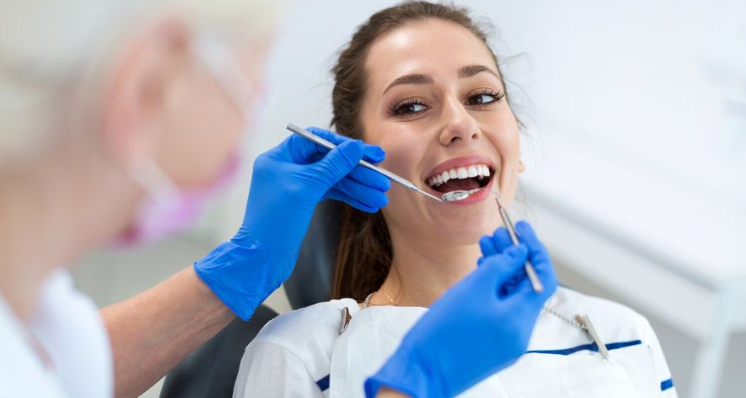 Woman receiving dental check-up from dentist.