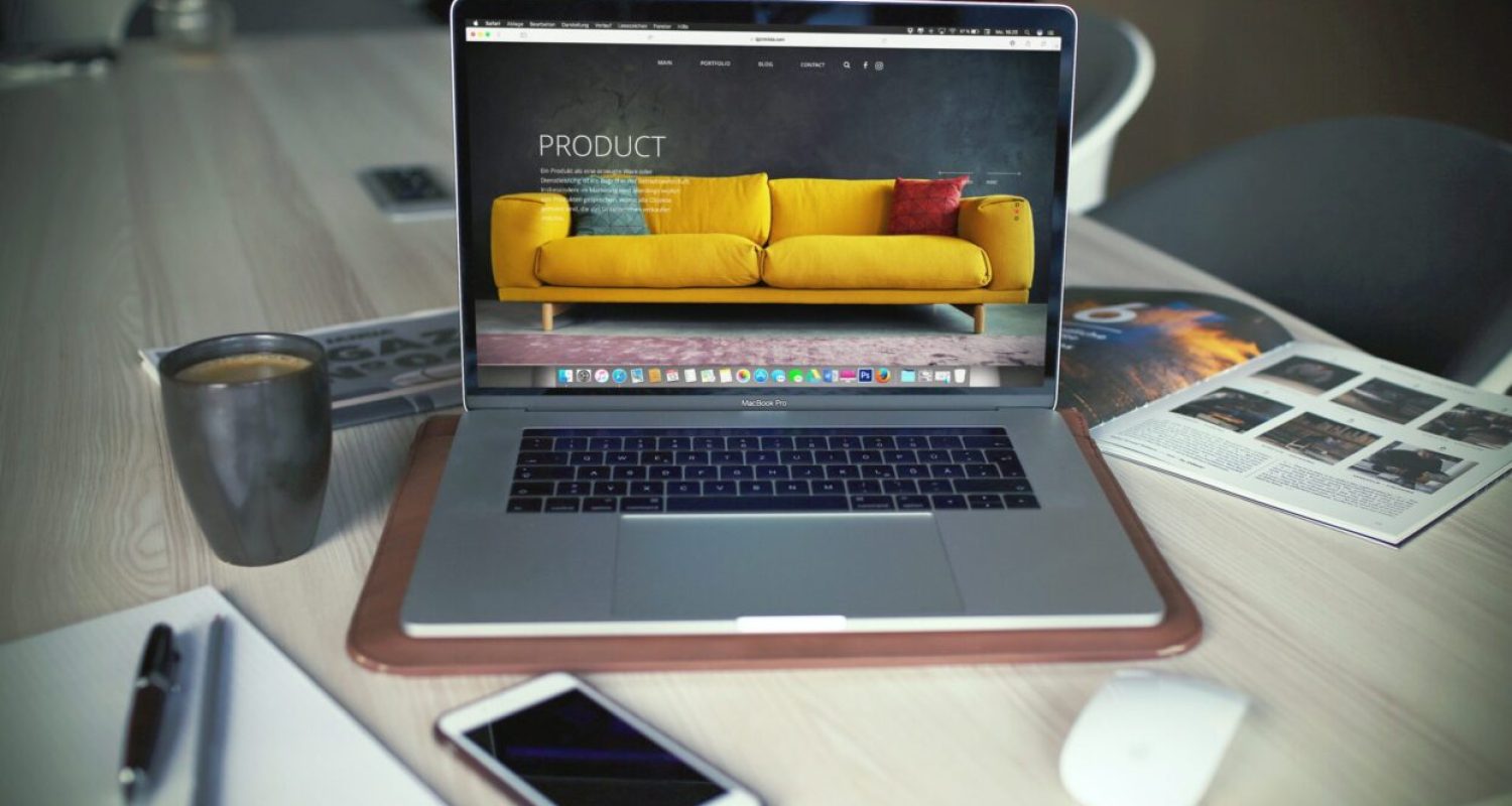 Laptop with couch on screen, table setup